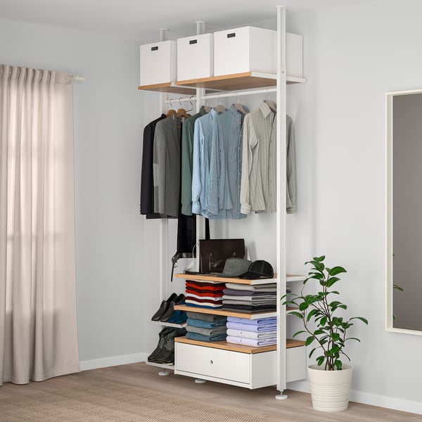 Modern white ELVARLI storage unit with clothes, shelves & plant. Tall & organised, perfect for bedrooms.
