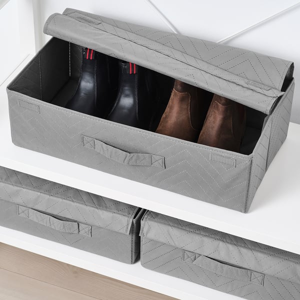 Grey FULLSMOCKAD storage box holding boots, perfect for closet organisation.