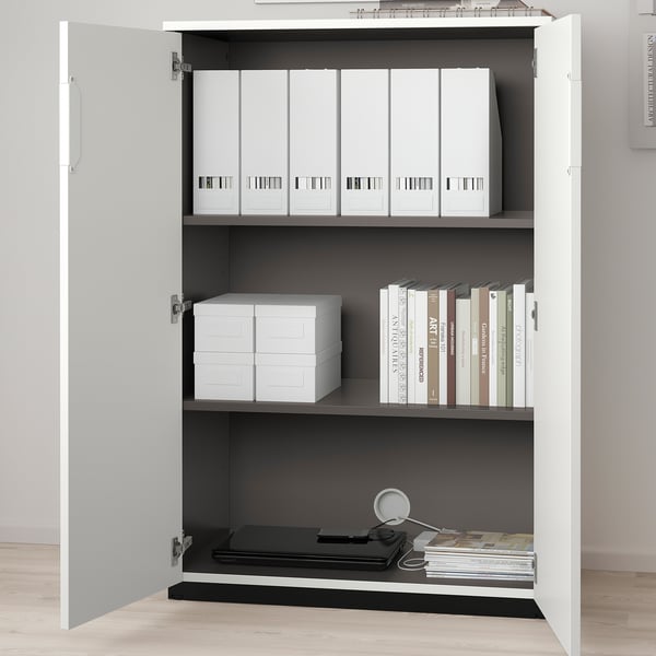 White GALANT cabinet with three shelves displaying sorted documents, books, and storage boxes.