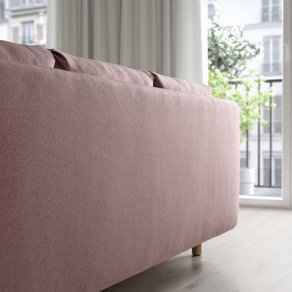 Modern sofa facing window, includes under seat storage for versatility.