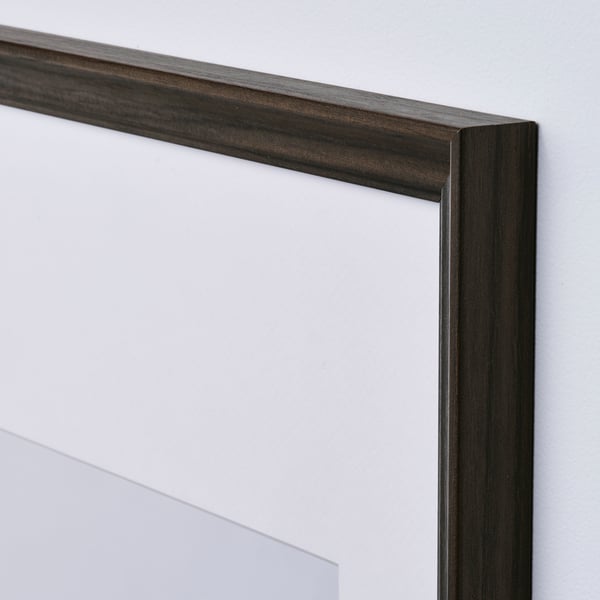 Close-up of minimalist picture frame with sleek, dark wood finish and clear protective cover.