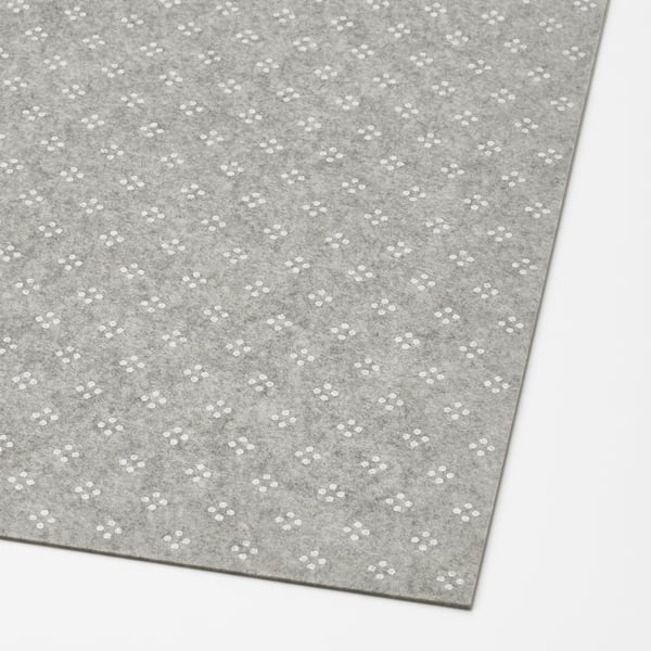 A grey drawer mat with small white dots, designed to prevent sliding and protect surfaces.