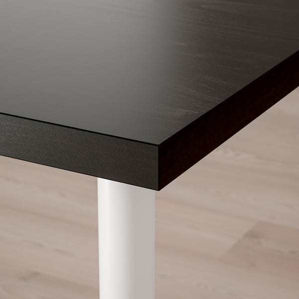 Black tabletop with dark finish, white leg, modern design.