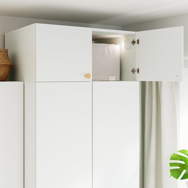 White cabinet with one open door revealing a white container inside. Safety hinges visible, created by LASTARE.