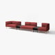 Modern modular red sofa set with clean lines and wooden legs, featuring a central black side table.