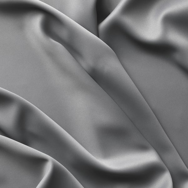 Smooth, grey curtains, neatly draped, showcasing textured fabric quality.