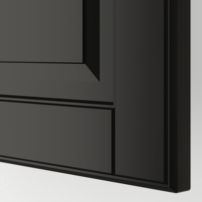Black kitchen cabinet with smooth finish and bevelled edges, showcasing modern design and high-quality materials.