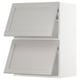 A white METOD kitchen cabinet system with light grey lerhyttan fronts, featuring bevelled edges and a classic, traditional design.
