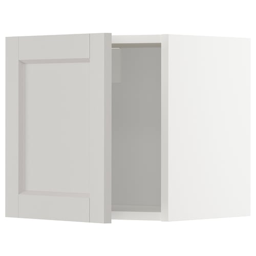 White METOD kitchen cabinet with beige frame and glass door.