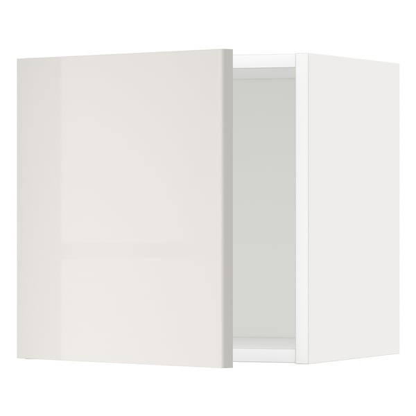 Modern, glossy white wall cabinet, slightly ajar in kitchen.