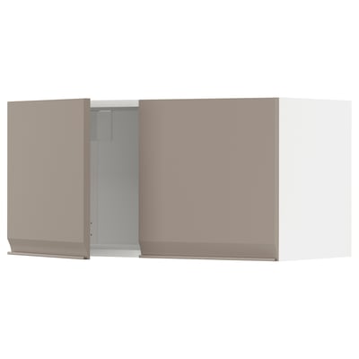 A pale pink METOD wall-mounted kitchen cabinet with a modern design, featuring a grey-beige door with a minimalist handle and chamfered edges.