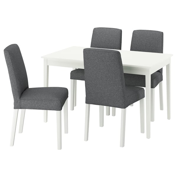 Modern white square dining table with four dark grey upholstered chairs.