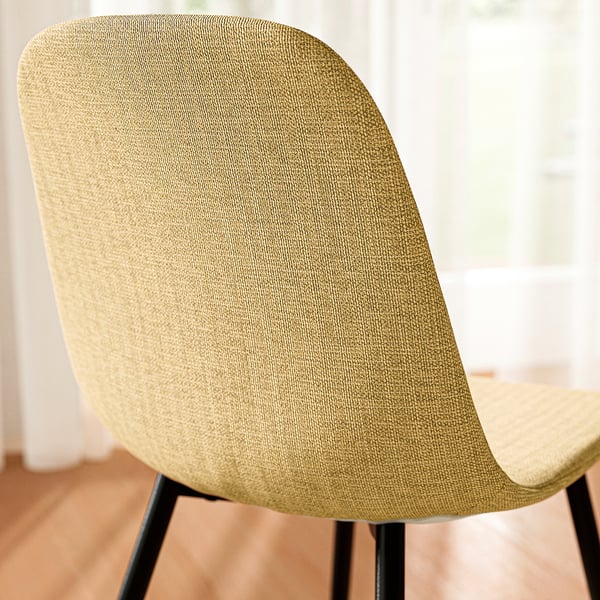 Modern chair with sleek design, upholstered in high-quality fabric, ensuring comfort and style.