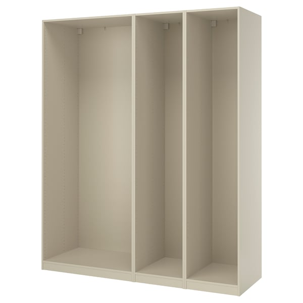 An ikea PAX wardrobe frame in white. It is a tall, rectangular, and modular unit with three sections, each featuring dowels for customizable shelving.