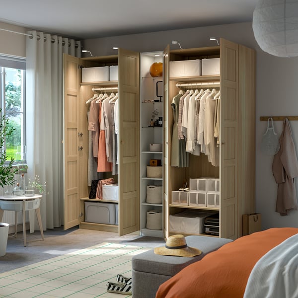 Wooden wardrobe with open doors displays neatly organised clothes and accessories, including shelves and drawers for efficient storage.