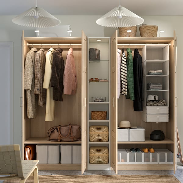 Organised wardrobe with hanging clothes, shelves, and storage boxes. Hinged doors and integrated lighting.