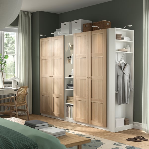 Large light PAX wardrobe with shelves, hanging clothes, and storage boxes. Dominates room.