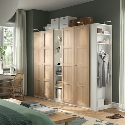 Large light PAX wardrobe with shelves, hanging clothes, and storage boxes. Dominates room.