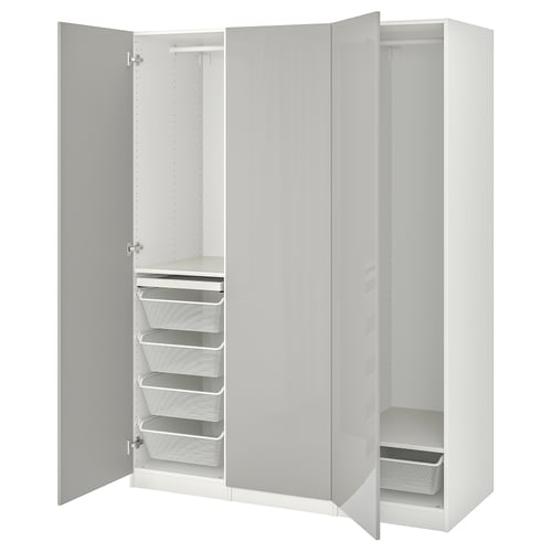 An open white PAX wardrobe with shelves, drawers, and mesh baskets for storage.