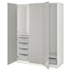 An open white PAX wardrobe with shelves, drawers, and mesh baskets for storage.