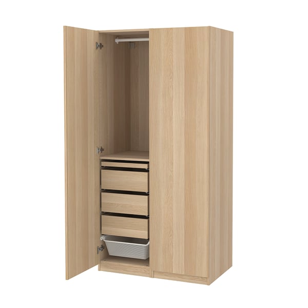 A light wood-colored standing wardrobe named PAX, featuring multiple drawers, a hanging rod, and a mesh basket.