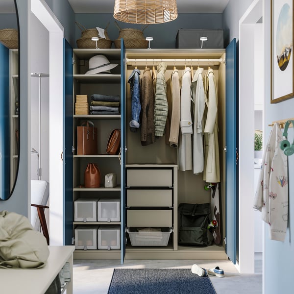 Organised closet with shelves, hangers, and storage bins; includes non-slip mat and mirror.
