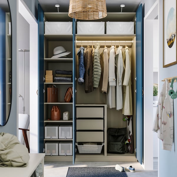 Organised wardrobe showcasing PAX system, featuring shelves for folded clothes, hanging rack, and storage boxes.