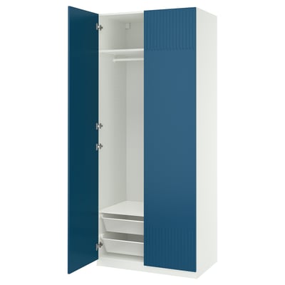 A blue and white PAX wardrobe with an open door revealing an empty interior, shelves, and drawers.