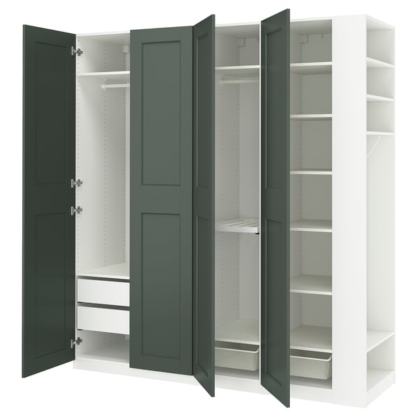 An open green IKEA PAX wardrobe. It shelves, drawers, and hanging storage with white interiors.