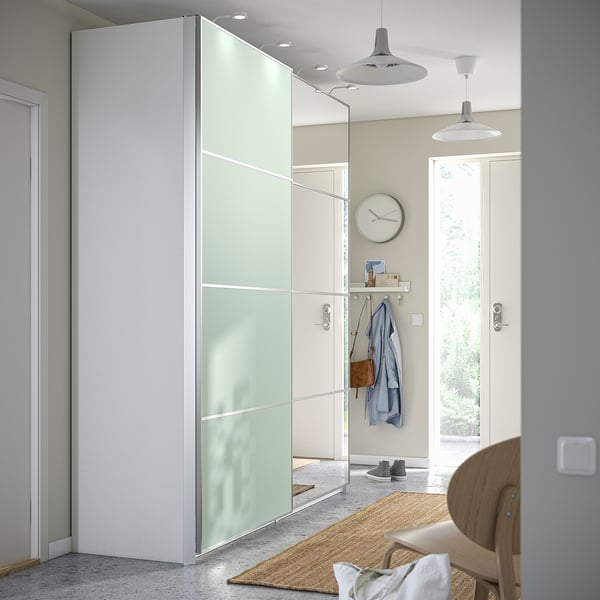 Modern closet with frosted doors, chair on jute rug.