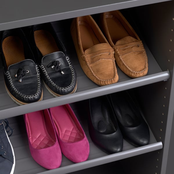 Shoes organised on modern, sturdy shelves; black, brown and pink pairs neatly displayed.