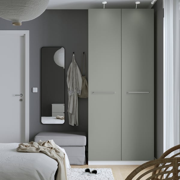 Modern grey bedroom with PAX wardrobe, mirror, and bed.