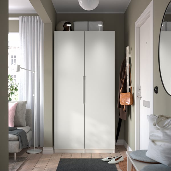 Modern PAX wardrobe with storage, lamp, coat rack, and seating.