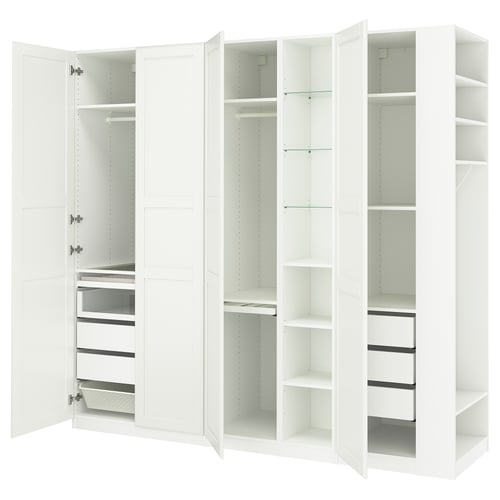 A white IKEA PAX wardrobe with open doors, revealing shelves and drawers inside.
