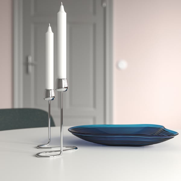 Silver candlestick with 2 white candles; elegant, minimalist design.