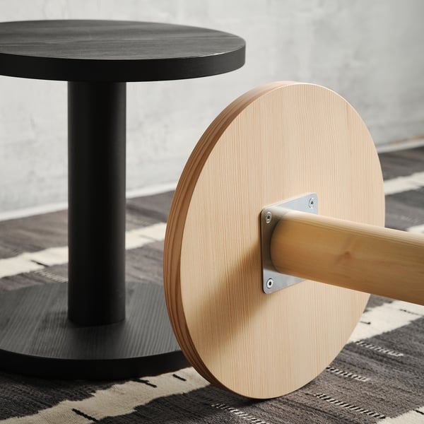 Modern side table with sleek, natural wood finish. Round top, sturdy base, and minimalist design. Suitable for various settings.