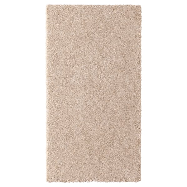 STOENSE beige soft rug, dense pile, rectangular shape, made from synthetic rubber and recycled polyester.