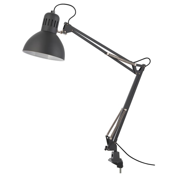A TERTIAL adjustable grey desk lamp with a metallic finish and a wide adjustable arm.