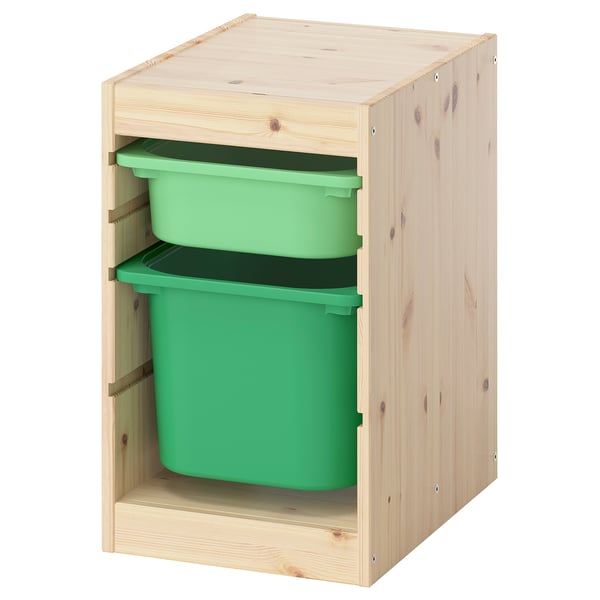 Green plastic bins in light wood cabinet.