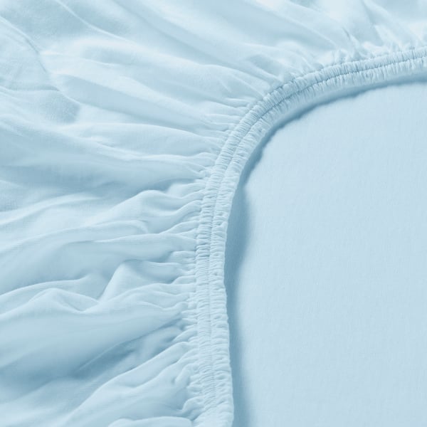 Close-up of light blue textured fabric with fine stitching, showcasing quality and detail.