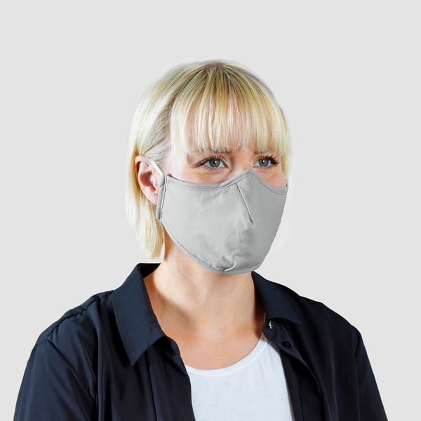 Blonde person wearing grey non-medical face mask. Mask shows embedded nose clip and compliant design.