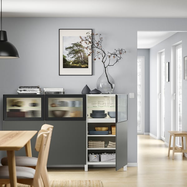 Modern living room with BESTÅ storage and nature photo.
