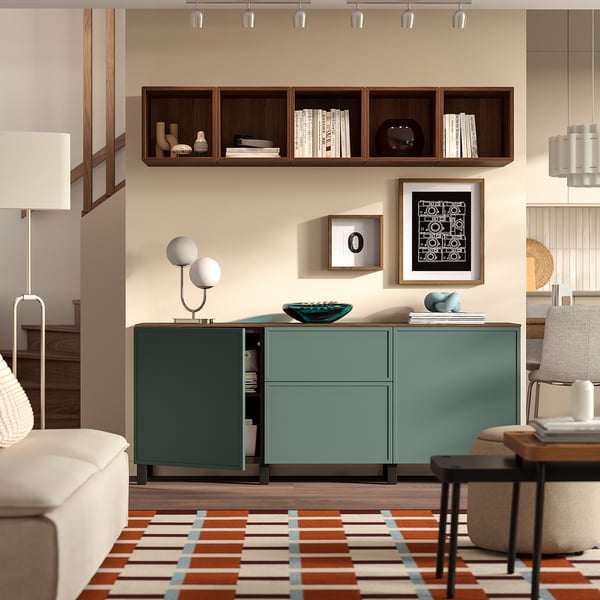 Modern living room with teal sideboard, abstract art, & plush seating.