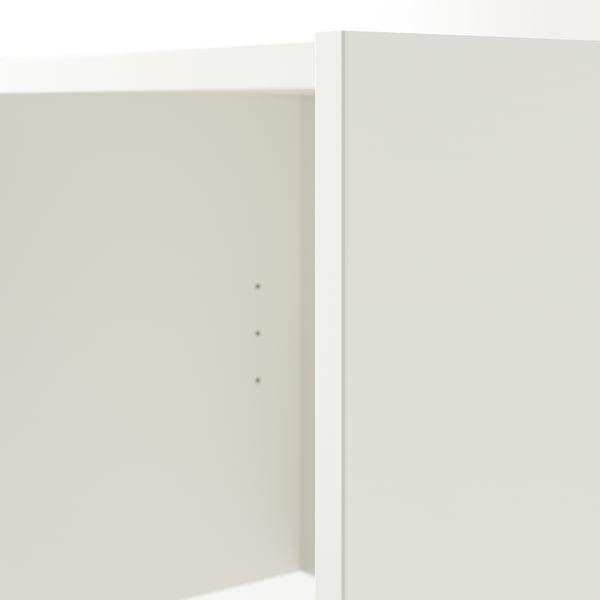 Minimalist white bookshelf with clean lines and no visible shelves.