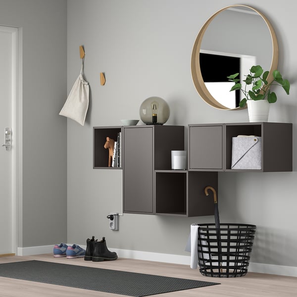 Modern entryway with EKET shelves, mirror, plant, and hooks.