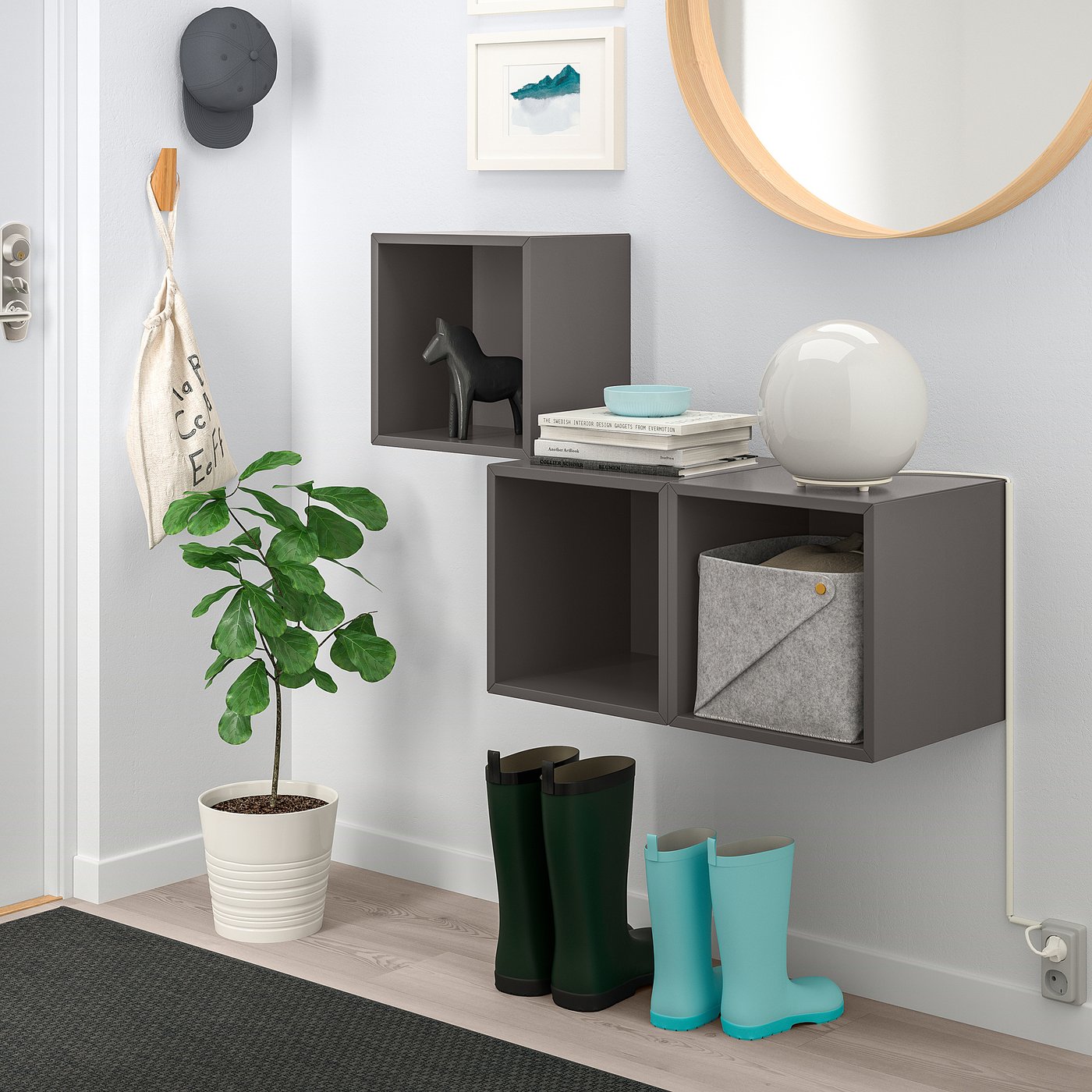 Black EKET wall unit with open & closed cabinets, decor items, and accessories.