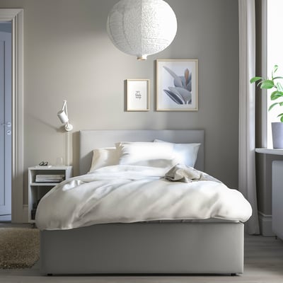 Minimalist bedroom with GLADSTAD bed, white linens, hanging light, art, nightstand, plant.