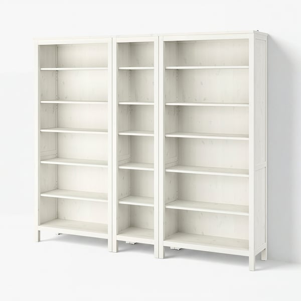 Two white wooden HEMNES bookcases, each with six adjustable shelves for versatile storage, featuring a traditional design.