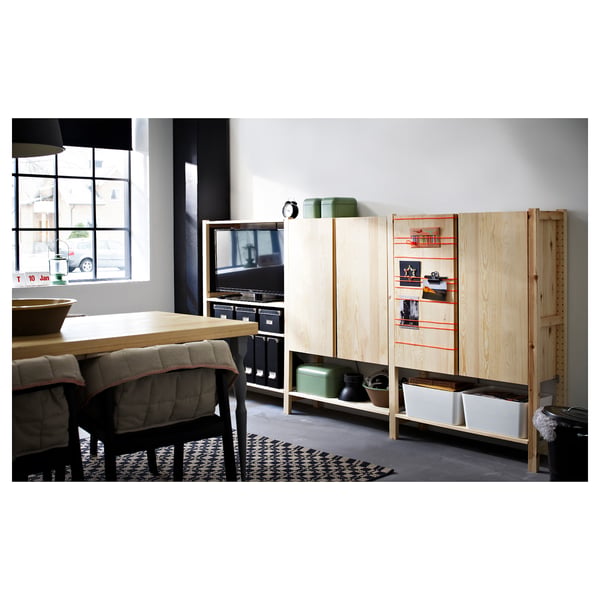Modern living room with IVAR storage units, light wood, and black accents.
