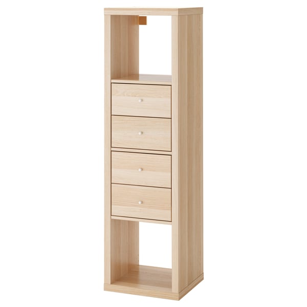A KALLAX light wood bookshelf four drawers, two empty compartments, and a minimalist design.
